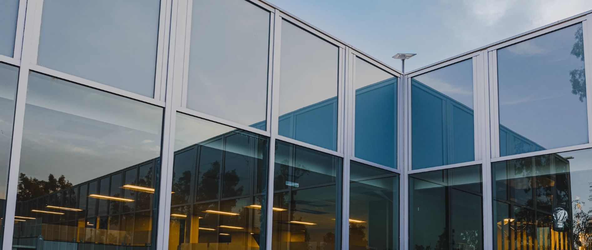 Modern glass-fronted business premises at dusk